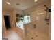 Bright bathroom featuring a glass shower, a soaking tub with window, and tile floors at 442 Snow Owl Way, Lawrenceville, GA 30044