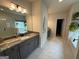 Bright bathroom featuring double sink vanity and a separate shower and soaking tub at 442 Snow Owl Way, Lawrenceville, GA 30044