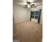 Spacious bedroom with neutral walls, carpet, window with drapes, and ceiling fan at 442 Snow Owl Way, Lawrenceville, GA 30044