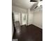 This bedroom boasts hardwood floors, a ceiling fan, and access to an ensuite bathroom at 442 Snow Owl Way, Lawrenceville, GA 30044
