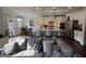 Open concept living and kitchen area with a large gray sofa and a kitchen with white cabinets and island at 442 Snow Owl Way, Lawrenceville, GA 30044