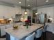 Bright kitchen with white cabinets, granite countertops, stainless steel appliances and a large center island at 442 Snow Owl Way, Lawrenceville, GA 30044