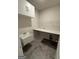 Modern laundry room with sink, countertop, upper cabinets, and pet nook at 442 Snow Owl Way, Lawrenceville, GA 30044