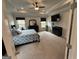 Spacious bedroom featuring plush carpet, a ceiling fan, and abundant natural light at 442 Snow Owl Way, Lawrenceville, GA 30044