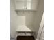 Bright mudroom featuring white bench, coat hooks, and overhead cabinets at 442 Snow Owl Way, Lawrenceville, GA 30044