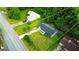 Scenic aerial view of a beautiful property with a long driveway and lush landscaping, surrounded by mature trees at 1183 Iron Gate Blvd, Jonesboro, GA 30238