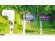 Overhead view of a well-maintained property with a long driveway and mature landscaping, nestled among lush trees at 1183 Iron Gate Blvd, Jonesboro, GA 30238