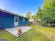 Home back yard features a concrete patio, a spacious yard, and partial fencing at 1183 Iron Gate Blvd, Jonesboro, GA 30238