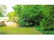 Large back yard with a wooded tree line and wood fence at 1183 Iron Gate Blvd, Jonesboro, GA 30238