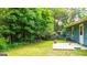 Lush backyard featuring mature trees and a concrete patio, perfect for outdoor entertaining at 1183 Iron Gate Blvd, Jonesboro, GA 30238