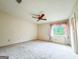 Cozy bedroom featuring a ceiling fan, a window with curtains, and carpet flooring at 1183 Iron Gate Blvd, Jonesboro, GA 30238