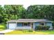Cozy one-story home with blue siding, red shutters, and a manicured lawn at 1183 Iron Gate Blvd, Jonesboro, GA 30238