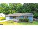 Charming one-story home with blue siding, red shutters, and a manicured front lawn at 1183 Iron Gate Blvd, Jonesboro, GA 30238
