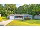 Charming home exterior featuring a well-maintained lawn and front porch at 1183 Iron Gate Blvd, Jonesboro, GA 30238