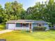 Charming home exterior featuring a well-maintained lawn and front porch at 1183 Iron Gate Blvd, Jonesboro, GA 30238