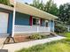 Charming front porch with lattice railing, brick steps, and lush landscaping at 1183 Iron Gate Blvd, Jonesboro, GA 30238