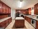 Traditional kitchen features wood cabinets, a center island, and modern appliances at 1183 Iron Gate Blvd, Jonesboro, GA 30238