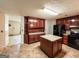 Bright kitchen featuring wood cabinets, tile floor, and an island at 1183 Iron Gate Blvd, Jonesboro, GA 30238