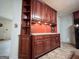 Spacious kitchen features wood cabinets, upper shelving and counter space at 1183 Iron Gate Blvd, Jonesboro, GA 30238
