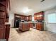 Traditional kitchen with wood cabinets, central island, and tile flooring at 1183 Iron Gate Blvd, Jonesboro, GA 30238