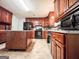 Well-lit kitchen with wooden cabinets, tile floors, and a center island for ample counter space at 1183 Iron Gate Blvd, Jonesboro, GA 30238