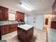Open kitchen with central island, stainless sink, and view to the hallway at 1183 Iron Gate Blvd, Jonesboro, GA 30238