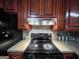 Kitchen features range, vent hood, cherry cabinets, and plenty of counter space at 1183 Iron Gate Blvd, Jonesboro, GA 30238