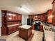 Well-lit kitchen with wood cabinets, tile floors, and center island at 1183 Iron Gate Blvd, Jonesboro, GA 30238