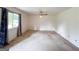 Sunlit living room with large window, ceiling fan, and floral curtains at 1183 Iron Gate Blvd, Jonesboro, GA 30238