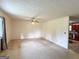 Bright living room with neutral walls, ceiling fan, and view of kitchen at 1183 Iron Gate Blvd, Jonesboro, GA 30238