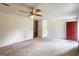Open living room featuring ceiling fan and access to the exterior at 1183 Iron Gate Blvd, Jonesboro, GA 30238