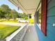 Relaxing porch view overlooking a green lawn, driveway, and lush landscaping at 1183 Iron Gate Blvd, Jonesboro, GA 30238