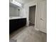 Bathroom featuring a double sink vanity, ample counter space, and a separate water closet at 1317 Rosemary Ln # 65, East Point, GA 30344