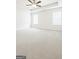 Bright, carpeted bedroom with two windows, neutral paint, and a ceiling fan creating a serene atmosphere at 1317 Rosemary Ln # 65, East Point, GA 30344