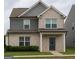 Charming two-story home with a combination of brick and siding, complemented by a well-maintained lawn at 1317 Rosemary Ln # 65, East Point, GA 30344