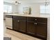 Spacious kitchen island featuring granite countertops, dark cabinets, stainless steel appliances, and a sink at 1317 Rosemary Ln # 65, East Point, GA 30344