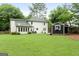 Expansive backyard featuring a shed, patio, and well-manicured lawn at 407 Calgary Dr, Peachtree City, GA 30269