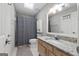 Bright bathroom featuring a shower with a patterned curtain, a toilet, and a granite vanity at 407 Calgary Dr, Peachtree City, GA 30269