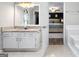 Bathroom with granite counters, a vanity, and an open door to the Primary bedroom with a luxurious king bed at 407 Calgary Dr, Peachtree City, GA 30269