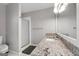 Updated bathroom featuring a glass-door shower, and a vanity with granite counters at 407 Calgary Dr, Peachtree City, GA 30269