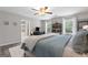 Bright bedroom with a ceiling fan, bedside bookshelves, large windows, and an ensuite bathroom at 407 Calgary Dr, Peachtree City, GA 30269