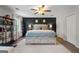 This bedroom boasts a ceiling fan, statement wall with décor, and a luxurious king-size bed with storage drawers at 407 Calgary Dr, Peachtree City, GA 30269