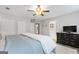Relax in this bedroom featuring a ceiling fan and a doorway to a bathroom with a soaking tub at 407 Calgary Dr, Peachtree City, GA 30269