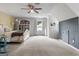 Spacious carpeted bedroom featuring a ceiling fan and natural light from a window at 407 Calgary Dr, Peachtree City, GA 30269