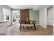 Open floor plan with a dining area featuring a modern table, chairs, and sliding barn door at 407 Calgary Dr, Peachtree City, GA 30269