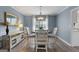 Inviting dining room featuring a modern light fixture, neutral paint, and wood floors at 407 Calgary Dr, Peachtree City, GA 30269