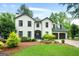 Charming two-story home with white brick exterior, manicured lawn, and a two-car garage at 407 Calgary Dr, Peachtree City, GA 30269