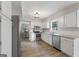 Bright kitchen with white cabinets, stainless steel appliances, and wood flooring at 407 Calgary Dr, Peachtree City, GA 30269