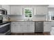 Modern kitchen featuring granite countertops, white cabinetry, and stainless steel appliances at 407 Calgary Dr, Peachtree City, GA 30269