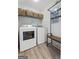 Laundry room featuring washer, dryer, shelving, and bench at 407 Calgary Dr, Peachtree City, GA 30269